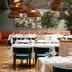 The Wellem Düsseldorf dining room with oversized woven pendant lights and set tables