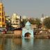 Hotel Pooja International, Nashik near waterfront temple structures and city skyline