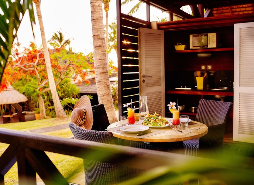 Iloha Seaview Hotel in Saint-Leu with a private patio, table setting, and tropical garden view.