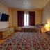 Ocean Beach Hotel in Miami Beach room with two floral-pattern beds, wall-mounted TV and window