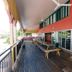 Global Backpackers Cairns Central in Cairns: covered outdoor terrace with picnic tables and glass doors