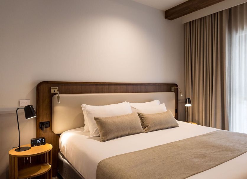 Thurgoona Country Club Resort Albury guest room with king bed, bedside lamps, and window curtains