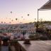 Anitya Cave House in Ürgüp terrace with wicker seating and hot air balloons over Cappadocia