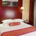 Gold River Side Hotel Jiaxing room with king bed, wall lamps, and red headboard