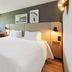 Campanile Nature - Mont De Marsan room with double bed, desk by window and framed wall art in Mont-de-Marsan