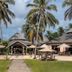 Ocean Beach Resort & Spa in Malindi with palm trees, thatched-roof buildings, and outdoor seating