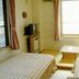 Villa Katashio in Nozawa Onsen guest room with twin beds, table, TV, and large window