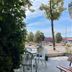 Hotel Falk, Bremen: outdoor terrace with tables and chairs overlooking a street and trees