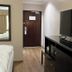 Hampshire Hotel - Ballito room with TV stand, kettle, and entry door in Ballito