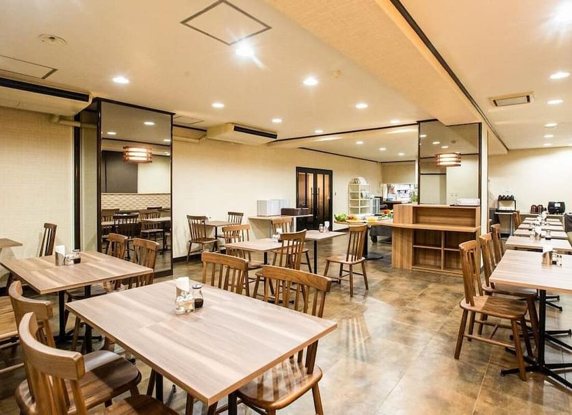 Hotel Sunplaza Sakai in Sakai breakfast dining room with wooden tables, chairs, and counter seating