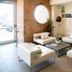 Smy Aran Blu Roma Mare lobby seating area in Lido di Ostia with modern white chairs and a round mirror