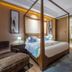 Lakeside Resort Jingdezhen bedroom with four-poster bed and view into bathroom