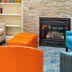 Holiday Inn Express & Suites Burlington - Mount Holly lobby lounge with fireplace and colorful chairs in Westampton