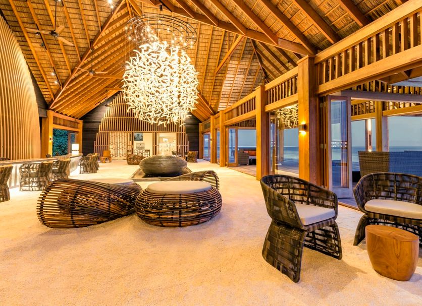 Hurawalhi Island Resort in Komandoo: airy overwater lounge with woven chairs and ocean views