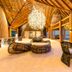 Hurawalhi Island Resort in Komandoo: airy overwater lounge with woven chairs and ocean views