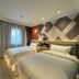 Mingcheng Hotel Beijing guest room with two twin beds and window drapes in Beijing