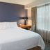 Residence Inn by Marriott New Bedford Dartmouth guest room with king bed, desk and window light