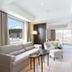 Chalet Ivy Hirafu, Niseko suite with sofa, armchairs, TV, and mountain view in Kutchan