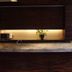 Center Hotel Toyota front desk with marble counter and warm backlit wood wall in Toyota