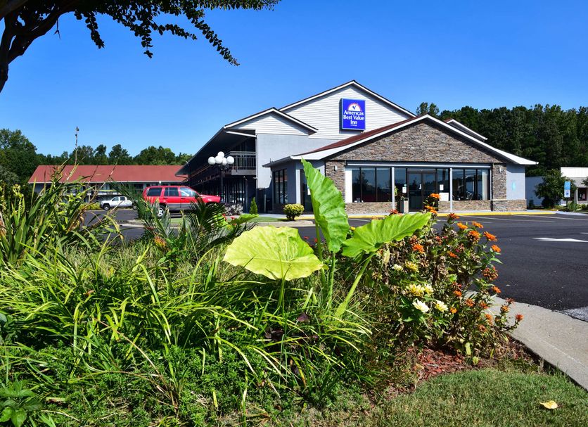 Americas Best Value Inn Douglasville exterior with landscaped greenery and clear blue sky