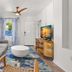 Hotel Cabana Clearwater Beach living room with gray sofa, TV, patterned rug and ocean view