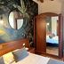 Hotel Al Sole Bardolino room with tropical mural wall, twin beds, wood ceiling and wardrobe