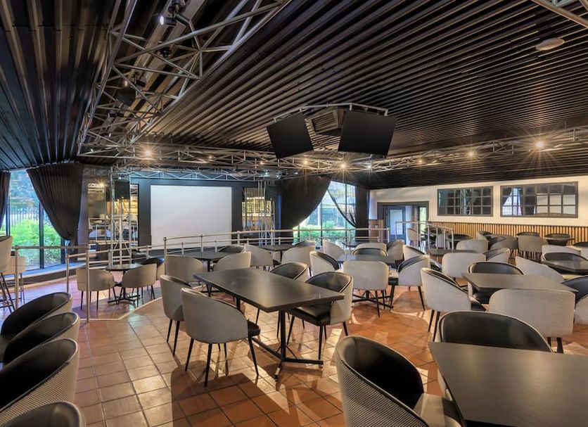 Park Hotel Mokopane in Mokopane dining area with tables, chairs, projector screen and large windows