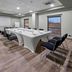 Meeting room at City Express Plus by Marriott Tijuana with conference table, chairs and projector screen