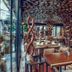 Shkoder Grand Europa Affiliated By Melia restaurant in Shkodër with wooden tables and stone columns