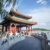 Mingcheng Hotel Beijing near a lakeside pavilion with ornate Chinese roof and waterfront view in Beijing