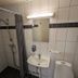 Örnvik Hotell & Konferens bathroom in Luleå with shower, sink, mirror, and toilet