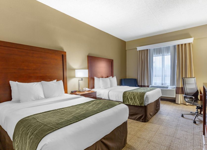 Comfort Inn Aikens Center Martinsburg guest room with two beds, desk, and window seating