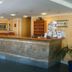 Hotel Art Sarajevo lobby front desk with carved stone-style reception counter and brochure rack