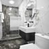 Imperial Palace Hotel Yerevan bathroom with marble walls, walk-in shower, vanity and toilet