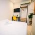 My Home Hotel Kuchai Lama room in Kuala Lumpur with bed, desk, chair and wall-mounted TV
