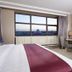 Holiday Inn & Suites Hulunbuir guest room with large window city view and desk