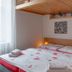 Penzion U Vlka in České Budějovice, guest room with double bed, lofted wood ceiling, and bedside lamps