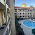 Super 8 by Wyndham The Woodlands North in Shenandoah with outdoor pool and hotel courtyard