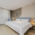 Home Inn Neo Shanghai Pudong Airport guest room with king bed, desk, and curtains in Shanghai