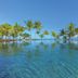Trou Aux Biches Beachcomber Golf Resort & Spa infinity pool with palm trees and ocean view in Trou Aux Biches