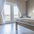 Hotel Whiskey in Pascagoula guest room with king bed and balcony doors to outdoor view