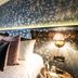 House Belfast Hotel in Belfast bedroom with floral wallpaper, upholstered headboard and bedside lamp