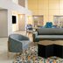Hampton Inn & Suites Fort Worth/Forest Hill lobby seating area with sofas, chairs and patterned rug