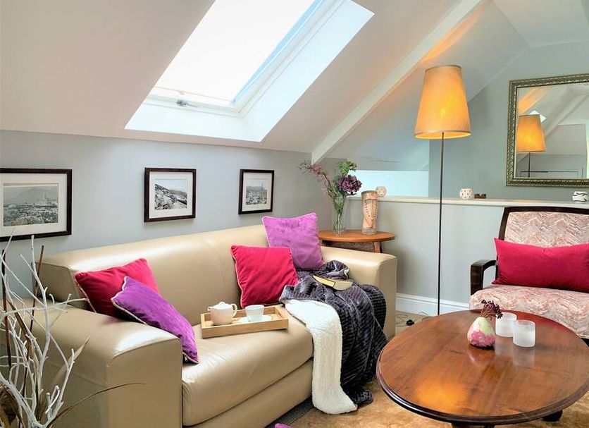 Abbey Manor Luxury Guesthouse in Cape Town: airy lounge with skylight, sofa, armchair and coffee table