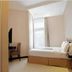 Vio Hotel Cimanuk Bandung guest room with bed, desk, chair, and bright window in Bandung