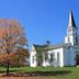 Holiday Inn Express & Suites Youngstown West - Austintown By IHG in Youngstown, white church with tall steeple and autumn trees