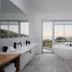 Sovn Experience+Lifestyle Cape Town bathroom with freestanding tub and mountain view through large windows