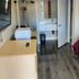 North Bay Inn Santa Rosa room with bed, desk, TV, sink area and open bathroom door