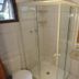 Pousada Atalaia bathroom with glass shower, toilet and granite sink in Campos do Jordão
