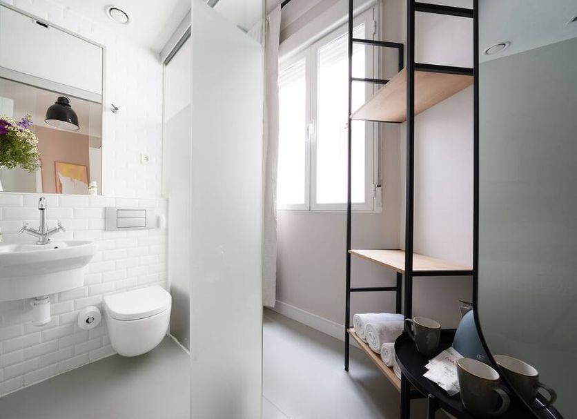 Bathroom at numa | Script in Madrid with sink, toilet, shower and shelving unit